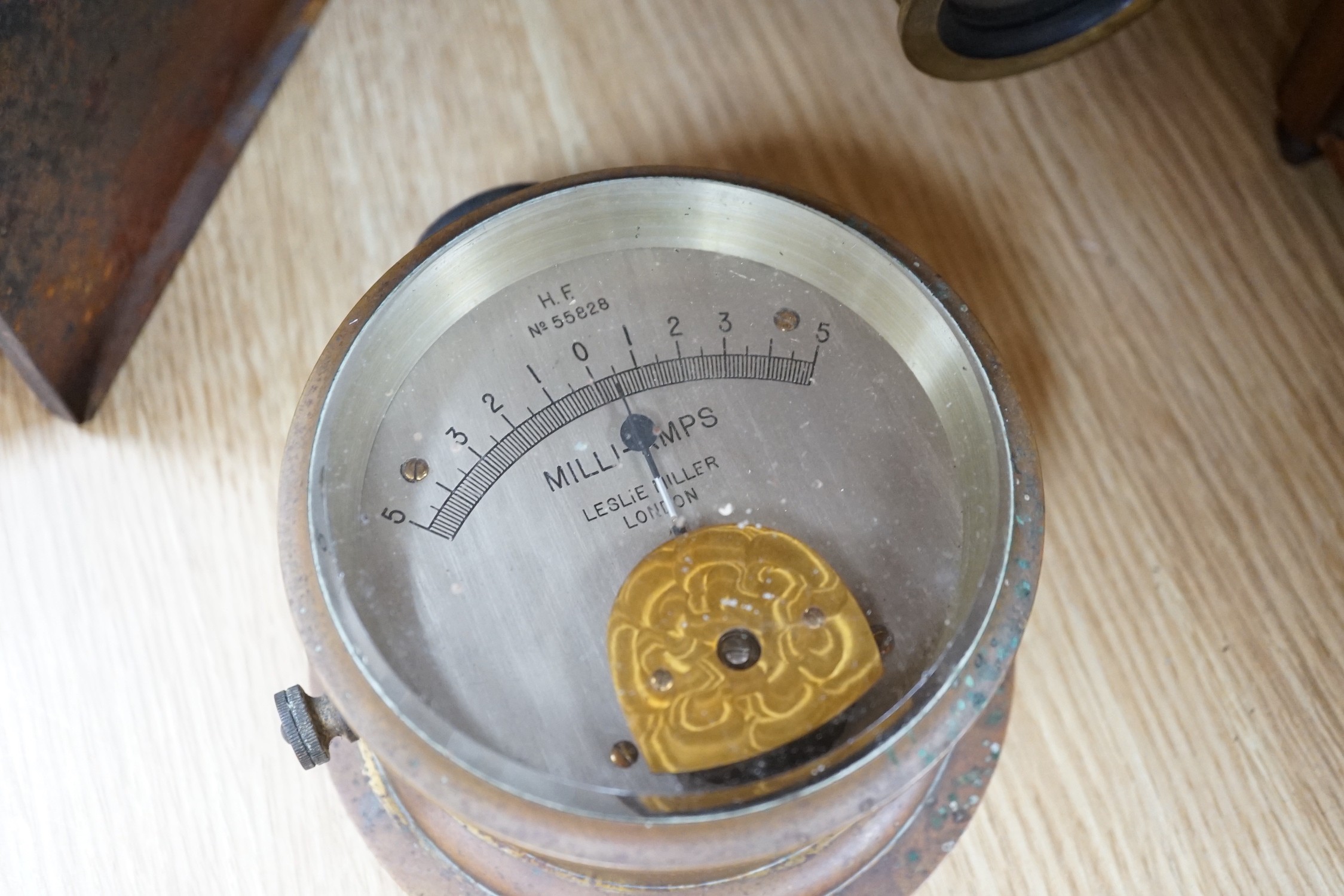 A cased tinplate and pressed brass Magic Lantern, Case 46 cm long, A French walnut cased mantel timepiece, with key, 23cm, and a brass cased Milli-Amps scale